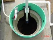 A second view of the pump chamber with the vault
         removed, showing the intake pipe.